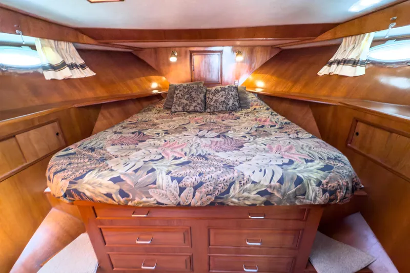 Silver Spring Yacht Photos Pics Luxurious cabin interior of 1985 Ocean Alexander 420 Sport Sedan with floral bedding.