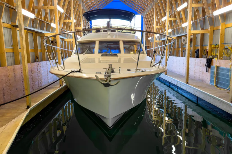 Silver Spring Yacht Photos Pics 1985 Ocean Alexander 420 Sport Sedan docked in a wooden boathouse.