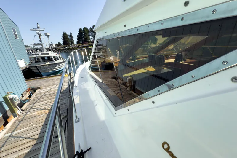 Silver Spring Yacht Photos Pics 1985 Ocean Alexander 420 Sport Sedan docked, showcasing sleek design and reflective windows.