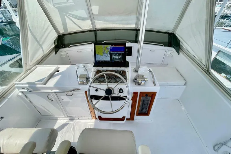Aqua Ma'am Yacht Photos Pics 1986 Ocean 38 Super Sport boat helm with steering wheel and navigation equipment.
