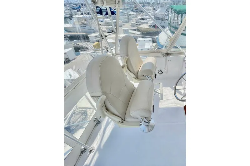 Aqua Ma'am Yacht Photos Pics Captain's chairs on 1986 Ocean 38 Super Sport yacht, overlooking marina.