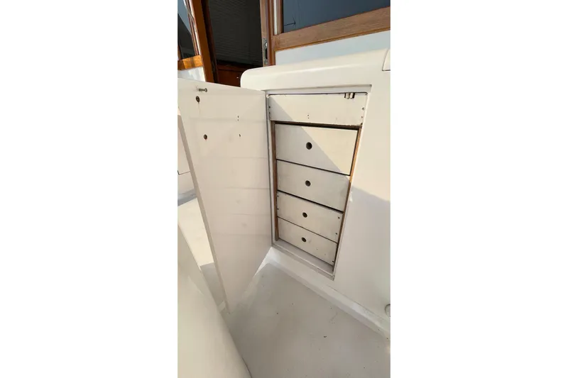 Aqua Ma'am Yacht Photos Pics 1986 Ocean 38 Super Sport boat storage cabinet with four drawers, open door.