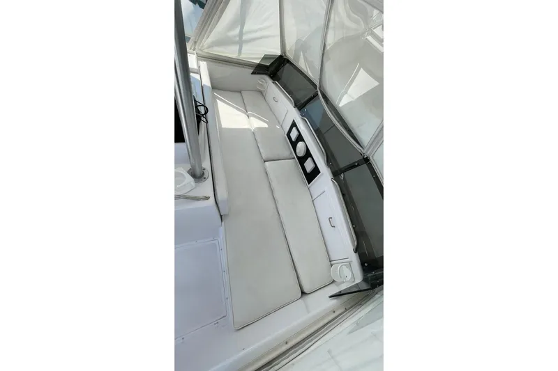 Aqua Ma'am Yacht Photos Pics 1986 Ocean 38 Super Sport boat interior with white cushioned seating and cup holders.