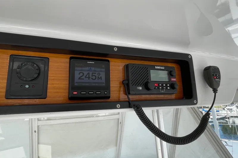 Aqua Ma'am Yacht Photos Pics Control panel of a 1986 Ocean 38 Super Sport boat with navigation and communication devices.