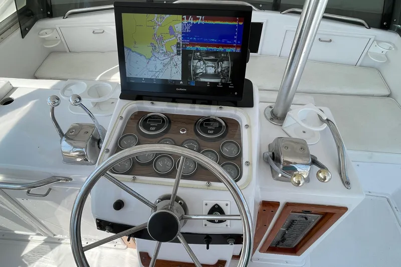 Aqua Ma'am Yacht Photos Pics 1986 Ocean 38 Super Sport helm with Garmin navigation display and classic controls.