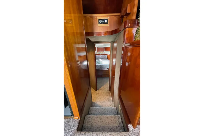 Aqua Ma'am Yacht Photos Pics Interior of 1986 Ocean 38 Super Sport yacht with wooden paneling and carpeted stairs.