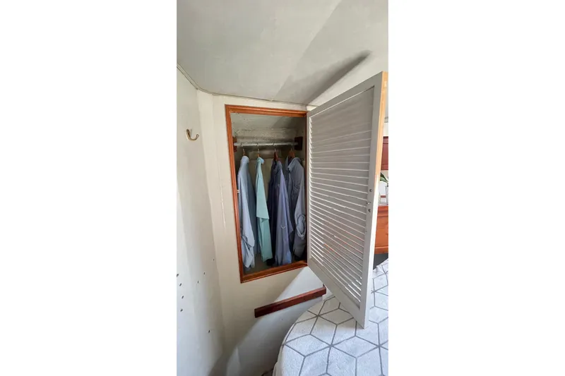 Aqua Ma'am Yacht Photos Pics Open closet with clothes inside on 1986 Ocean 38 Super Sport boat.