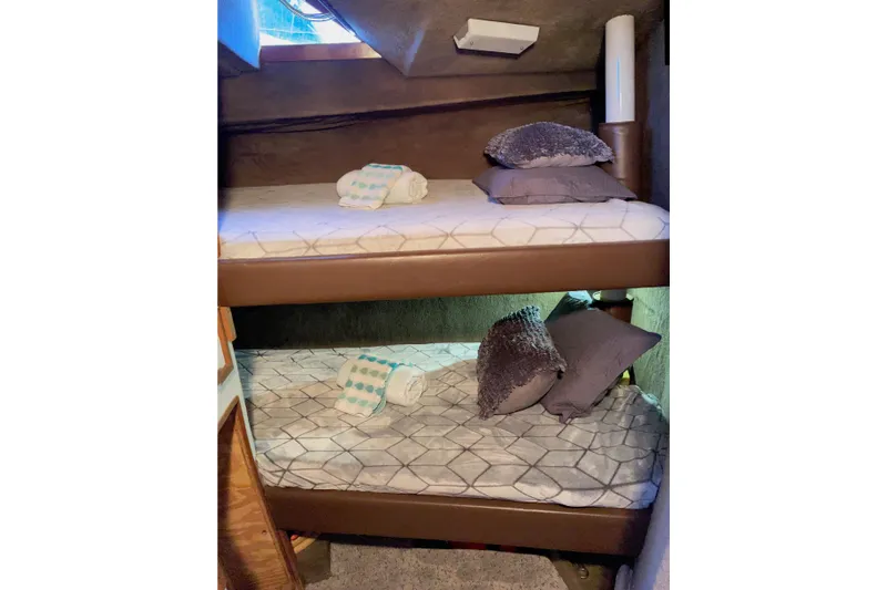 Aqua Ma'am Yacht Photos Pics Bunk beds in 1986 Ocean 38 Super Sport yacht cabin with cozy pillows and towels.
