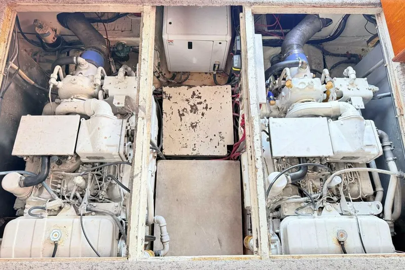 Aqua Ma'am Yacht Photos Pics Engine room of 1986 Ocean 38 Super Sport boat, featuring dual engines and mechanical components.