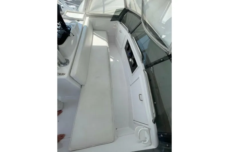 Aqua Ma'am Yacht Photos Pics 1986 Ocean 38 Super Sport boat interior with white seating and control panel.