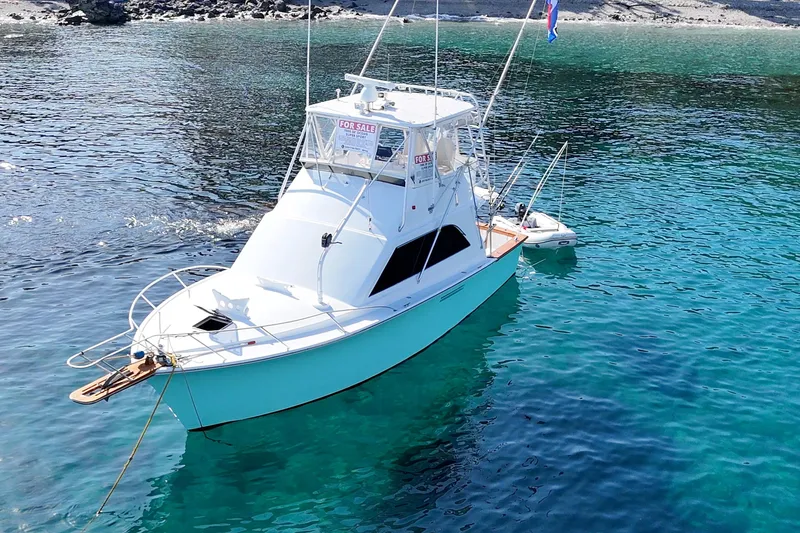 Aqua Ma'am Yacht Photos Pics 1986 Ocean 38 Super Sport boat anchored in clear blue water, for sale sign visible.