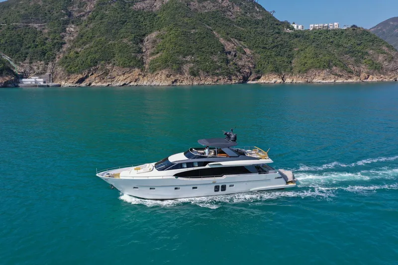  Yacht Photos Pics Sanlorenzo SL78 2017 yacht cruising in turquoise waters near lush green hills.