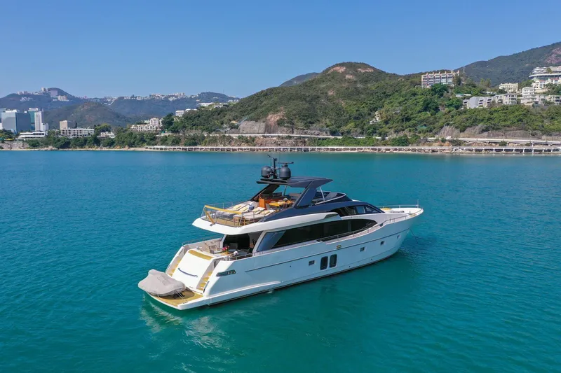  Yacht Photos Pics Sanlorenzo SL78 2017 yacht cruising in scenic coastal waters with lush hills in the background.