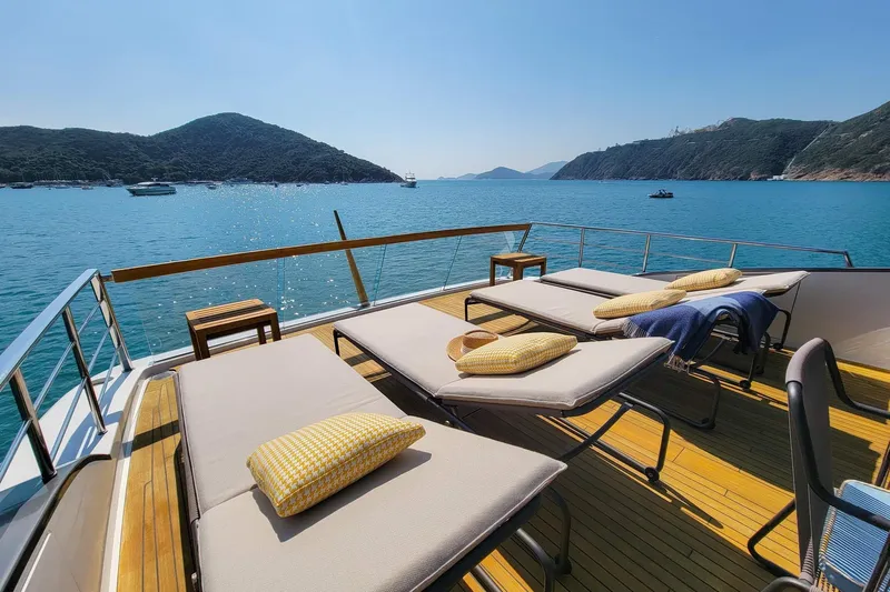  Yacht Photos Pics Luxurious 2017 Sanlorenzo SL78 yacht deck with sun loungers, overlooking serene blue waters.