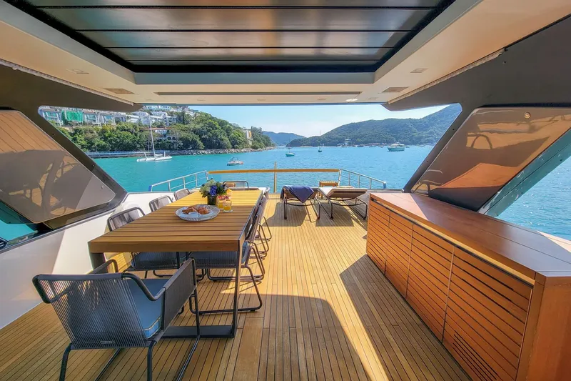  Yacht Photos Pics Luxurious 2017 Sanlorenzo SL78 yacht deck with dining area, overlooking serene blue waters.