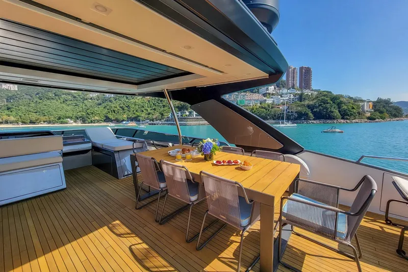  Yacht Photos Pics Luxurious 2017 Sanlorenzo SL78 yacht deck with dining area, overlooking scenic coastal view.