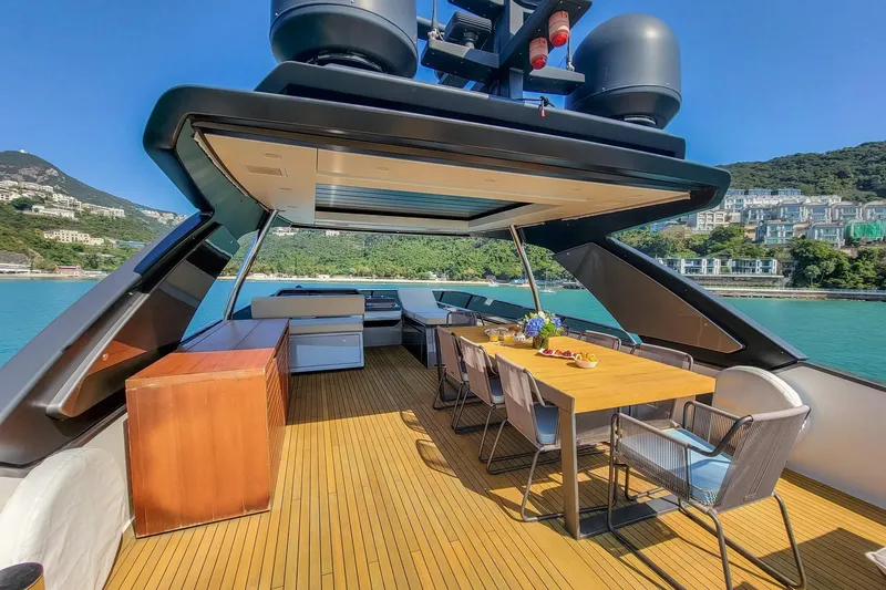  Yacht Photos Pics Luxurious 2017 Sanlorenzo SL78 yacht deck with dining area, overlooking serene coastal scenery.