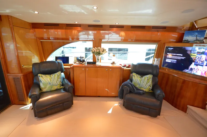  Yacht Photos Pics Luxurious interior of 2006 Hatteras 64 Motoryacht with leather chairs and entertainment system.