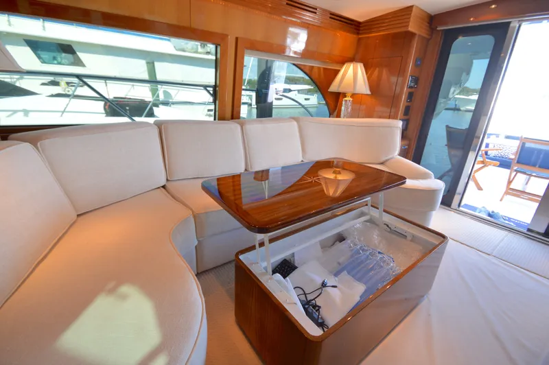  Yacht Photos Pics Luxurious interior of 2006 Hatteras 64 Motoryacht with elegant seating and wooden accents.