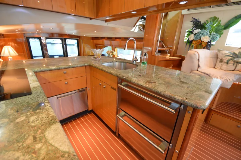  Yacht Photos Pics Luxurious kitchen interior of 2006 Hatteras 64 Motoryacht with granite countertops and modern appliances.