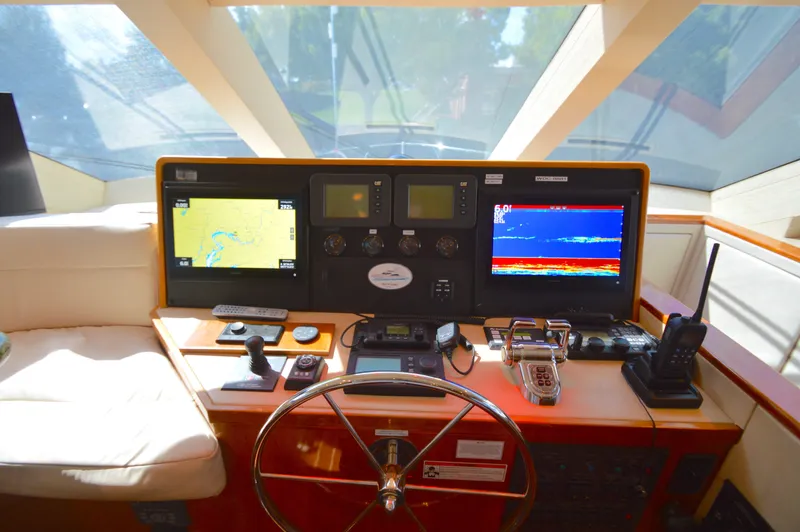  Yacht Photos Pics Helm of 2006 Hatteras 64 Motoryacht with navigation screens and controls.