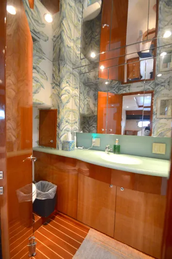  Yacht Photos Pics Luxurious bathroom in 2006 Hatteras 64 Motoryacht with elegant wood and mirrored accents.
