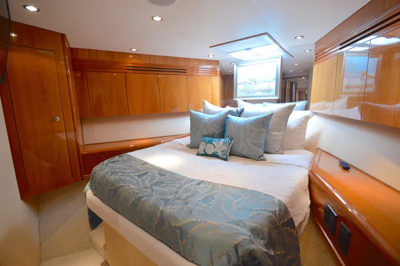  Yacht Photos Pics Luxurious bedroom interior of 2006 Hatteras 64 Motoryacht with elegant wood finishes and plush bedding.