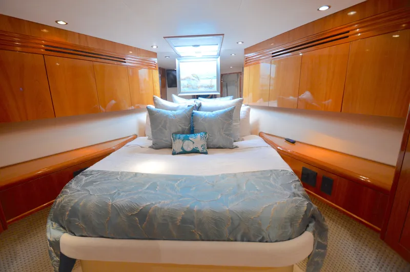  Yacht Photos Pics Luxurious bedroom interior of 2006 Hatteras 64 Motoryacht with elegant wood finish and plush bedding.