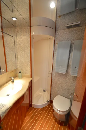  Yacht Photos Pics Luxurious bathroom in 2006 Hatteras 64 Motoryacht with shower, sink, and toilet.