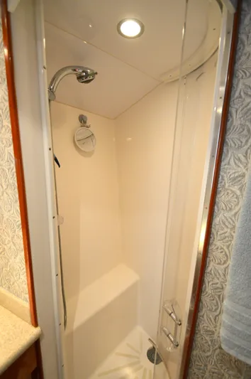  Yacht Photos Pics Shower area in 2006 Hatteras 64 Motoryacht, featuring modern fixtures and elegant design.