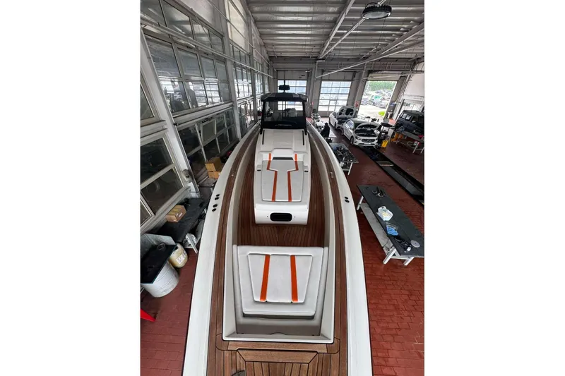  Yacht Photos Pics 2023 Technohull Omega 47 boat in a garage, showcasing sleek design and modern features.