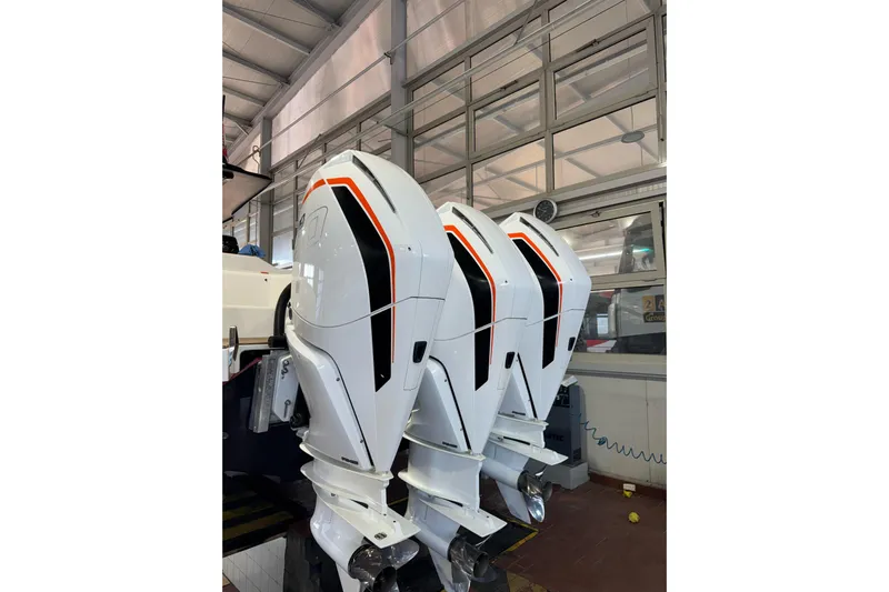  Yacht Photos Pics Three powerful outboard motors on a 2023 Technohull Omega 47 boat in a workshop.