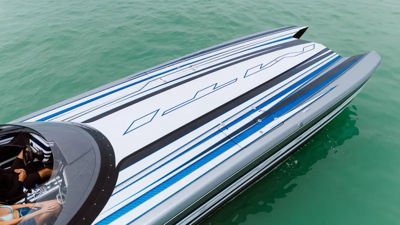  Yacht Photos Pics 2024 MTI 440X powerboat with sleek design and blue accents on turquoise water.