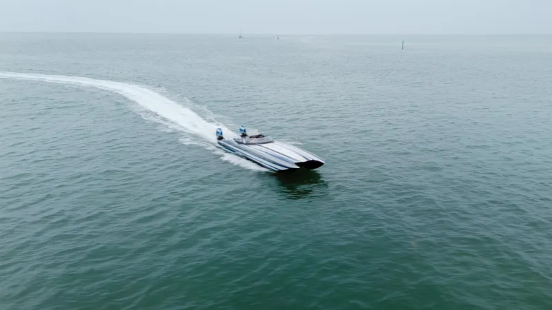  Yacht Photos Pics 2024 MTI 440X speedboat cruising on open water, leaving a trail behind.