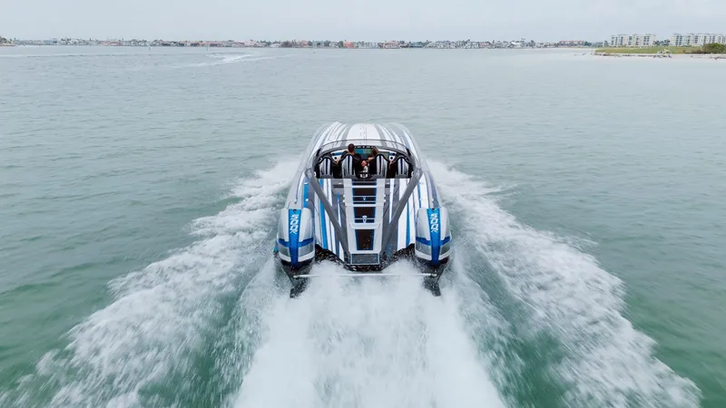  Yacht Photos Pics 2024 MTI 440X speedboat cruising on open water, showcasing sleek design and powerful performance.