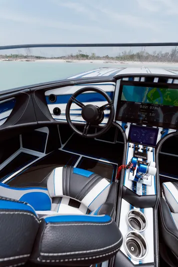  Yacht Photos Pics 2024 MTI 440X boat interior with modern dashboard, steering wheel, and navigation system.