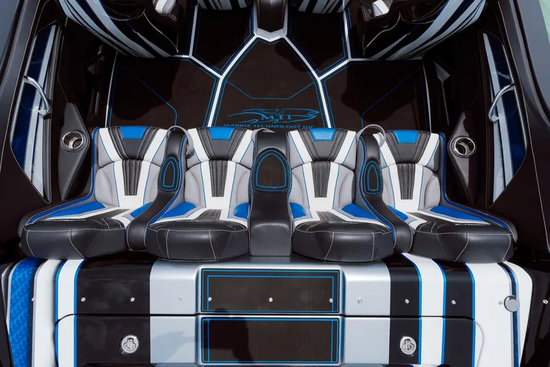  Yacht Photos Pics 2024 MTI 440X boat interior with sleek, modern seating in black, blue, and white design.