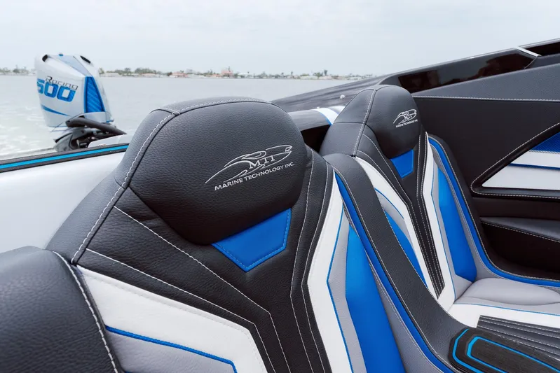  Yacht Photos Pics 2024 MTI 440X boat interior with blue and white seats, showcasing sleek design.