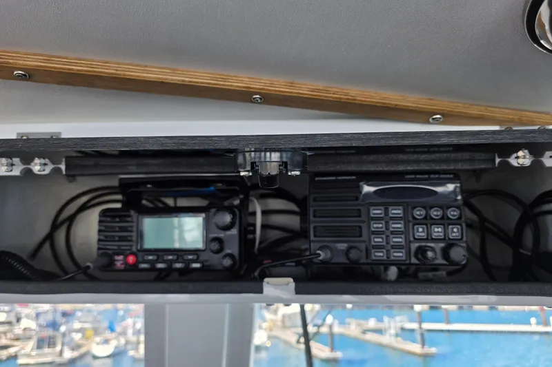Ocean Thunder Yacht Photos Pics Radio equipment inside a 1986 Gulf Craft Passenger boat, with marina view in background.