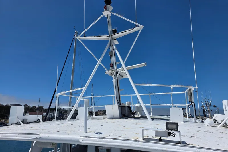 Ocean Thunder Yacht Photos Pics 1986 Gulf Craft Passenger boat deck with radar equipment under clear blue sky.