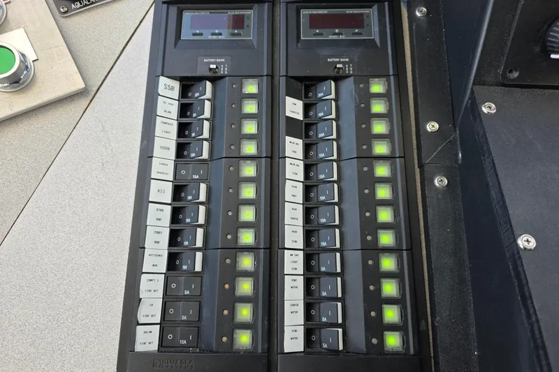 Ocean Thunder Yacht Photos Pics Control panel of a 1986 Gulf Craft Passenger boat with illuminated switches and indicators.