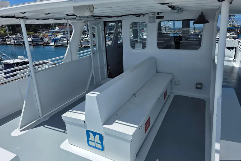 Ocean Thunder Yacht Photos Pics 1986 Gulf Craft Passenger boat interior with seating, docked at marina.