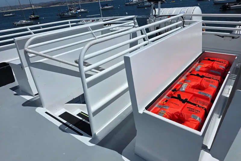 Ocean Thunder Yacht Photos Pics Open storage compartment with life jackets on a 1986 Gulf Craft Passenger boat deck.