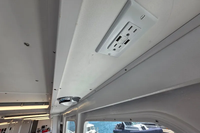 Ocean Thunder Yacht Photos Pics Interior view of 1986 Gulf Craft Passenger boat ceiling with electrical outlet and lighting.