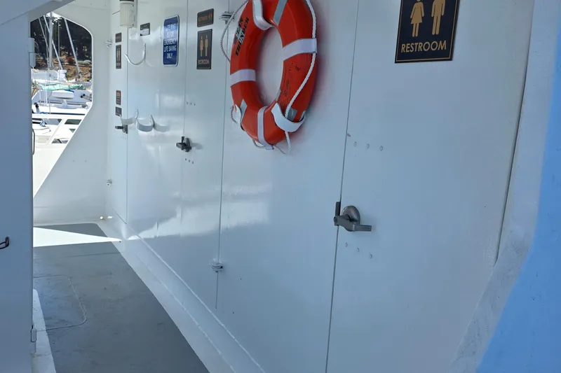 Ocean Thunder Yacht Photos Pics 1986 Gulf Craft Passenger boat interior with restroom signs and life preserver.