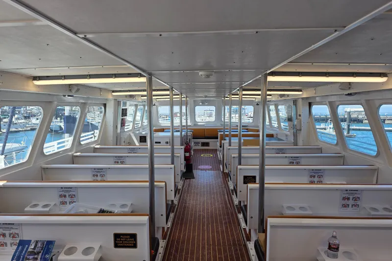 Ocean Thunder Yacht Photos Pics Interior of 1986 Gulf Craft Passenger boat with seating and large windows.