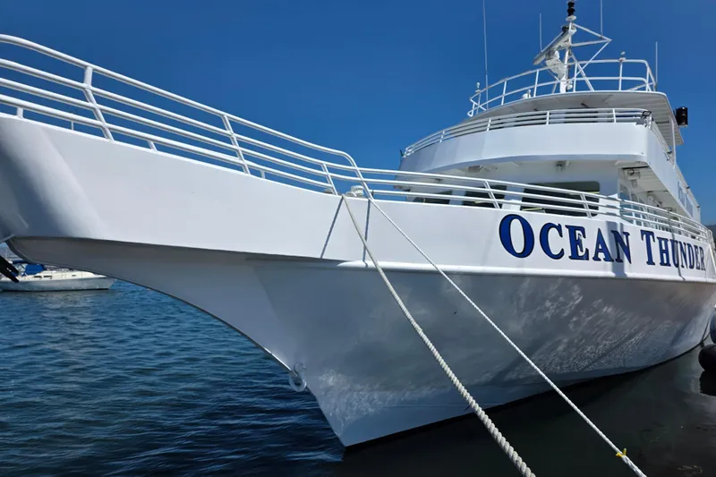 Ocean Thunder Yacht Photos Pics White Gulf Craft passenger boat "Ocean Thunder" docked, 1986 model, under clear blue sky.