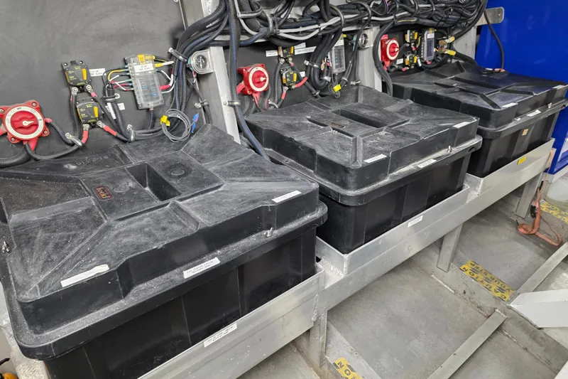 Ocean Thunder Yacht Photos Pics Battery compartment of a 1986 Gulf Craft Passenger vessel, featuring multiple black battery boxes.