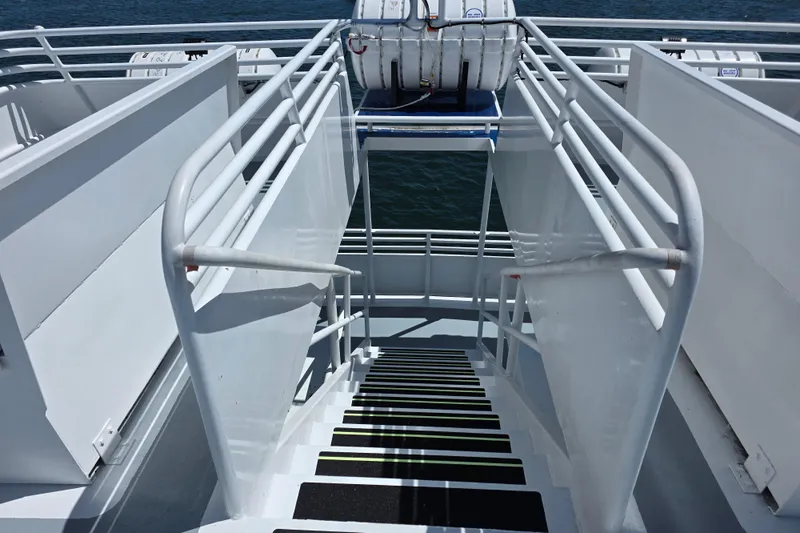 Ocean Thunder Yacht Photos Pics Staircase on 1986 Gulf Craft Passenger boat with safety railings and life raft.