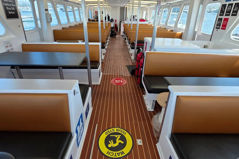 Ocean Thunder Yacht Photos Pics Interior of a 1986 Gulf Craft Passenger boat with seating and safety signage.